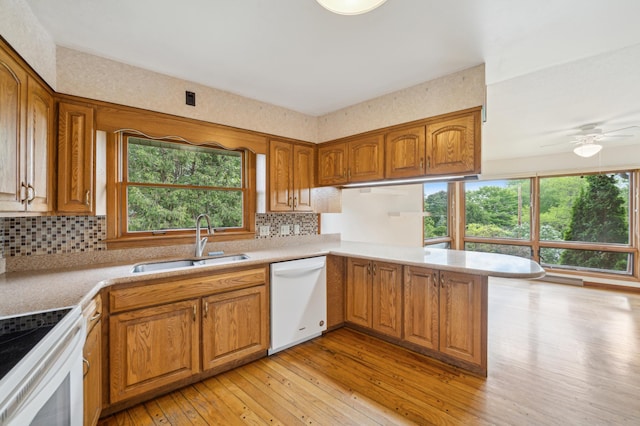 1615 2nd St N, Stillwater, MN 55082 - kitchen featuring white appliances, a sink, light wood-style flooring, brown cabinetry, and light countertops