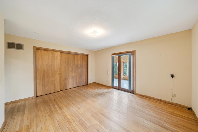 1615 2nd St N, Stillwater, MN 55082 - unfurnished bedroom featuring access to outside, light wood-style flooring, a closet, and baseboards