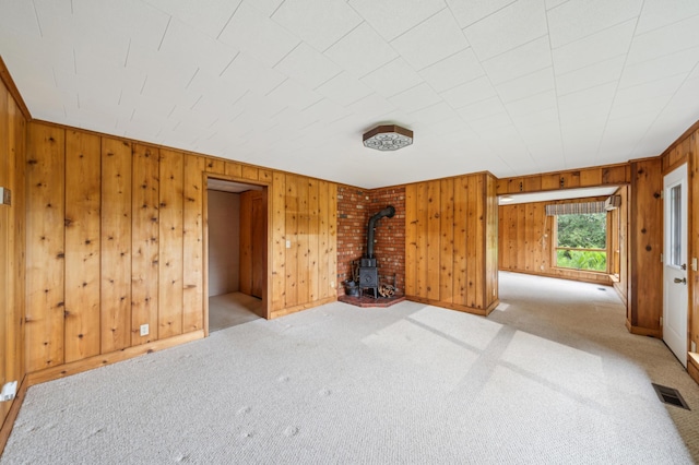 1615 2nd St N, Stillwater, MN 55082 - empty room with a wood stove, carpet, and wood walls