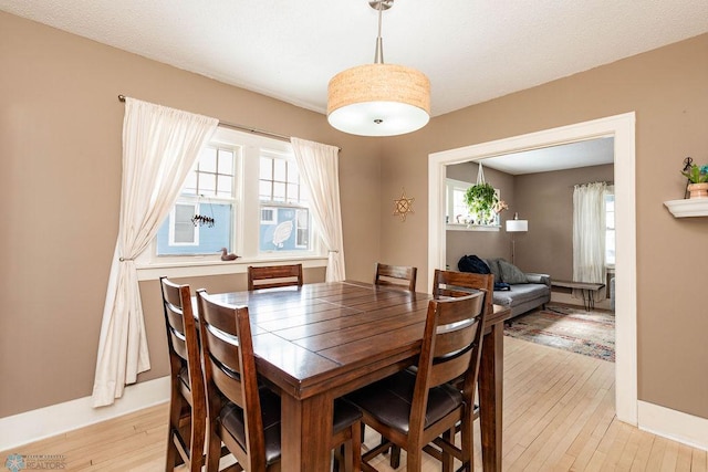 dining space featuring light wood finished floors