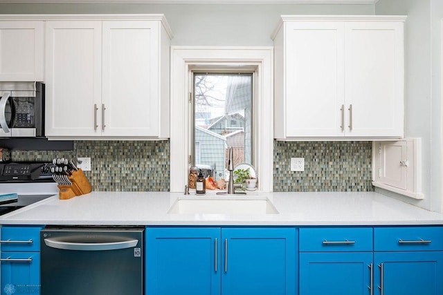 kitchen featuring a sink, blue cabinets, decorative backsplash, and appliances with stainless steel finishes