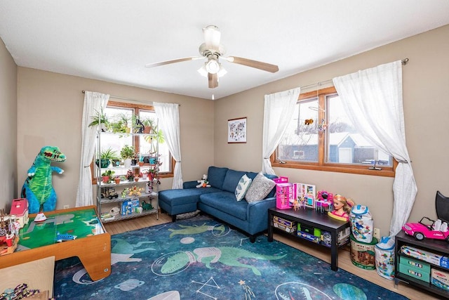 recreation room featuring wood finished floors and ceiling fan
