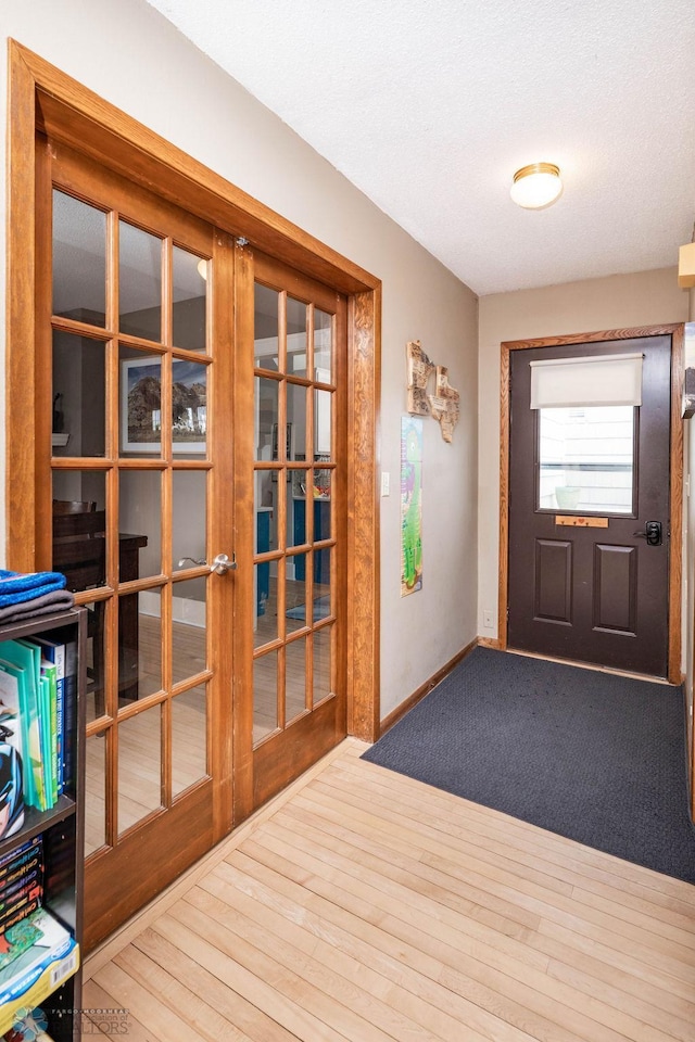 doorway featuring wood finished floors and french doors