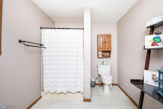 full bathroom with toilet, baseboards, and tile patterned flooring