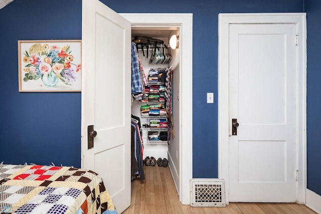bedroom featuring baseboards and wood finished floors