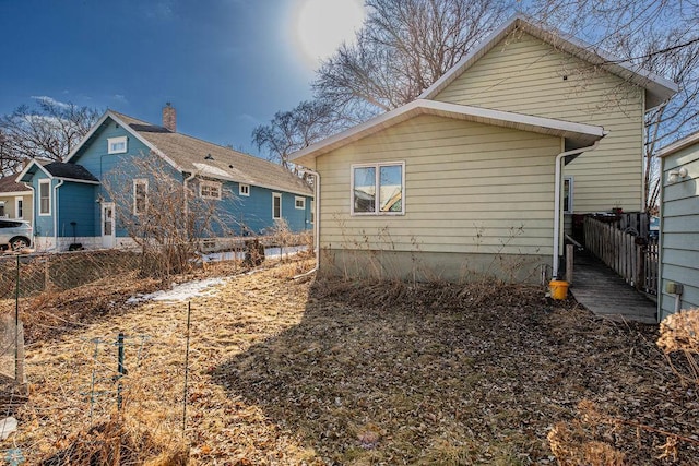 rear view of house with fence