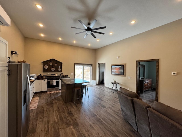 504 Lakin Ave NW, Kelliher, MN 56650 - kitchen featuring dark countertops, ceiling fan, stainless steel appliances, open floor plan, and dark wood-type flooring