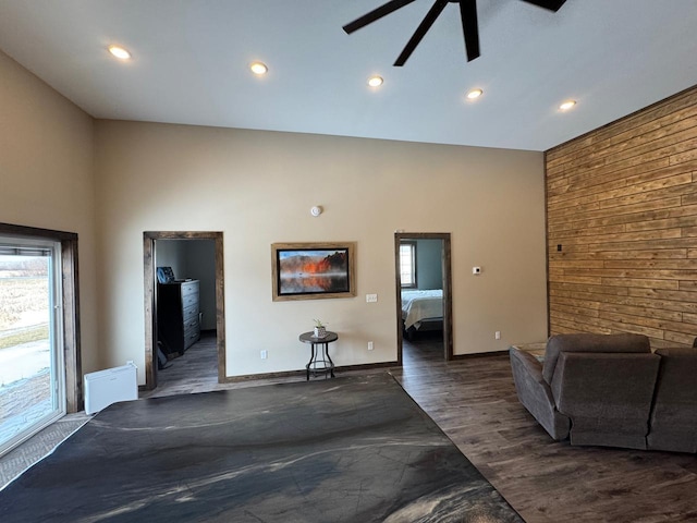 504 Lakin Ave NW, Kelliher, MN 56650 - unfurnished living room featuring recessed lighting, ceiling fan, wood walls, and wood finished floors