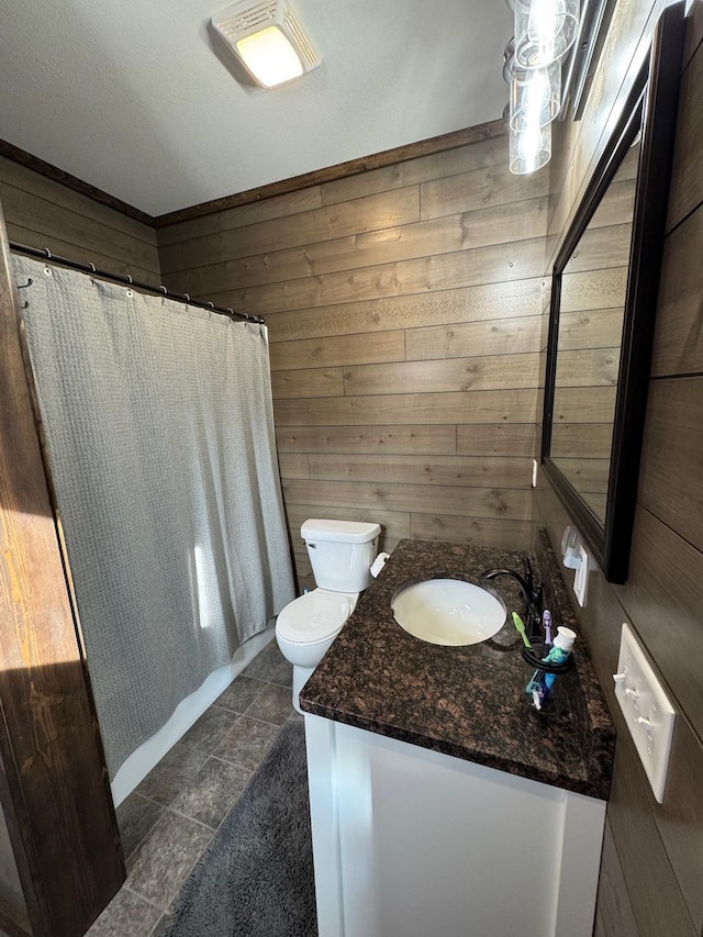 504 Lakin Ave NW, Kelliher, MN 56650 - bathroom featuring wooden walls, vanity, toilet, and curtained shower