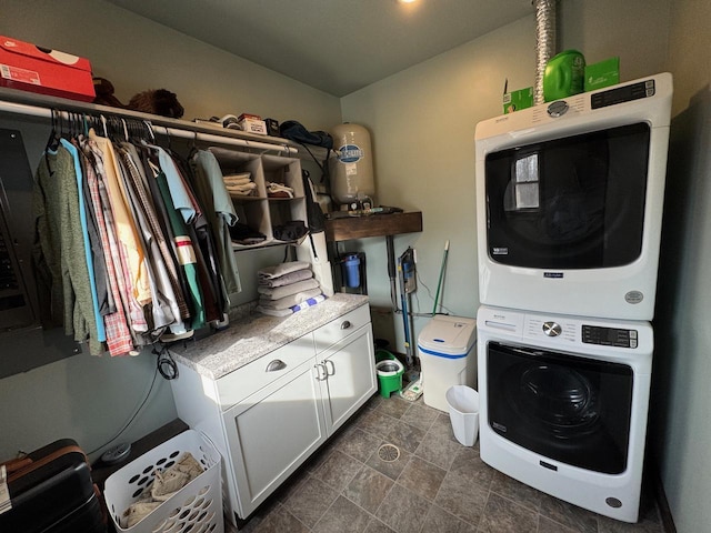 504 Lakin Ave NW, Kelliher, MN 56650 - laundry area featuring cabinet space and stacked washer / dryer