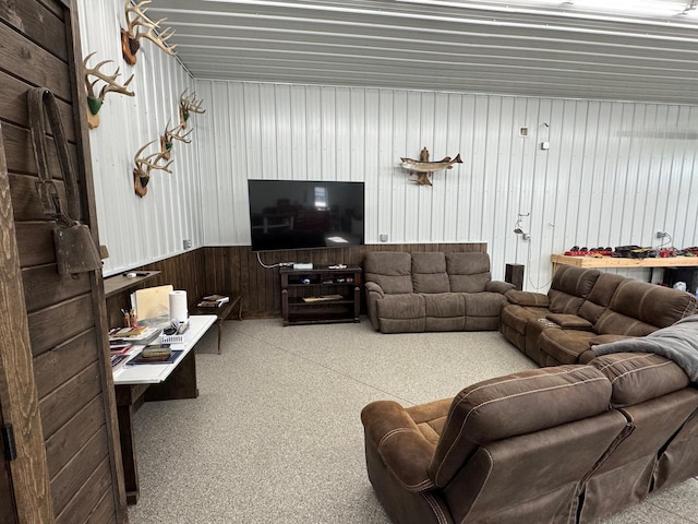 504 Lakin Ave NW, Kelliher, MN 56650 - living area with carpet floors, wainscoting, and wood walls