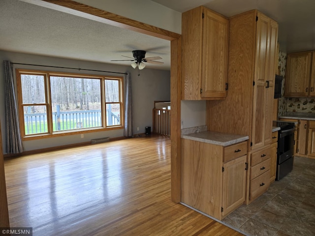 kitchen featuring decorative backsplash, a ceiling fan, electric range, dark wood finished floors, and light countertops