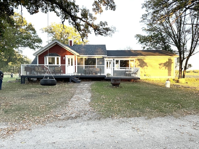 view of front of property with a wooden deck and a chimney