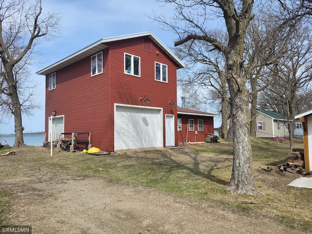 12972 Big Kandi Dr, Lake Lillian, MN 56253 - exterior space featuring driveway, a water view, and a garage