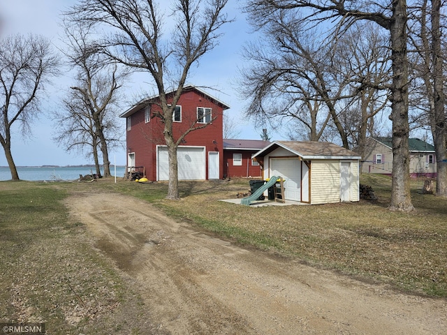 12972 Big Kandi Dr, Lake Lillian, MN 56253 - rear view of house with an outdoor structure, driveway, a water view, and a garage