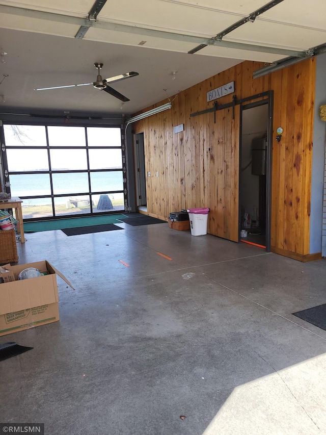 12972 Big Kandi Dr, Lake Lillian, MN 56253 - garage featuring wooden walls and a ceiling fan