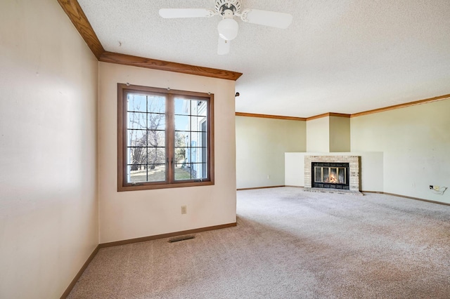 unfurnished living room featuring a textured ceiling, baseboards, visible vents, a brick fireplace, and carpet floors