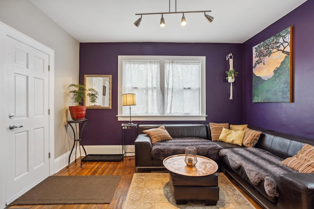 sitting room featuring baseboards and wood finished floors