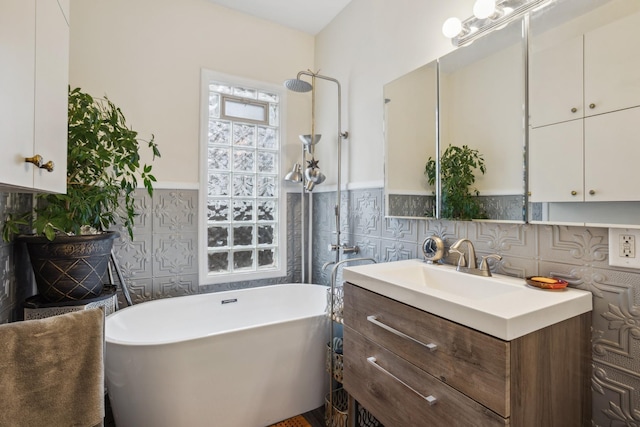bathroom featuring a freestanding tub, vanity, a wainscoted wall, a shower, and tile walls