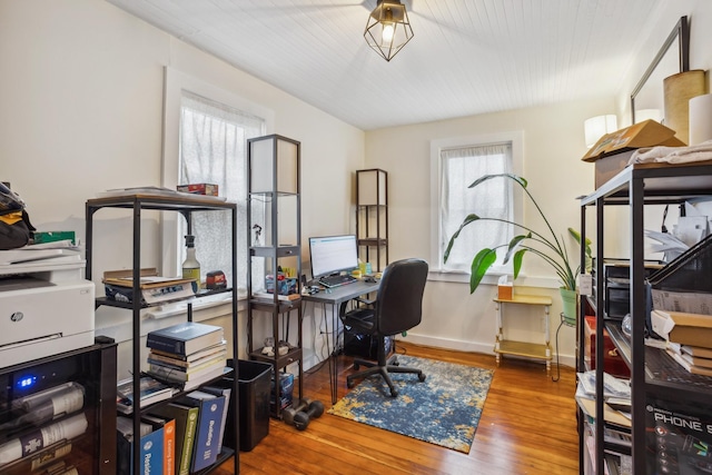 office space featuring baseboards and hardwood / wood-style flooring