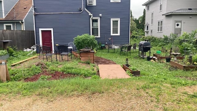 view of yard featuring fence and a vegetable garden