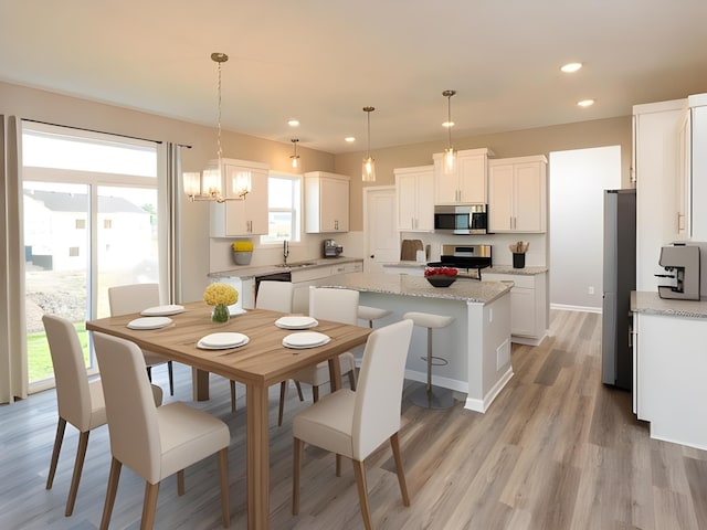 dining room with recessed lighting, light wood-style floors, baseboards, and a chandelier