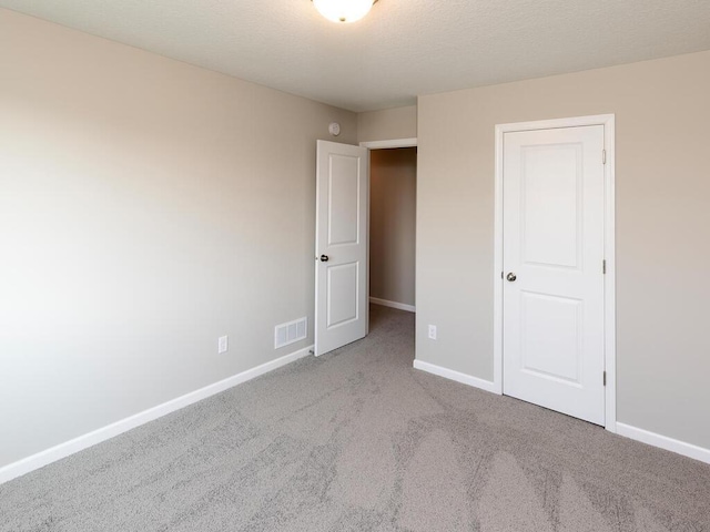 unfurnished bedroom featuring carpet floors and baseboards