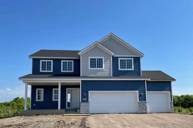 view of front of house with covered porch, dirt driveway, stone siding, and a garage