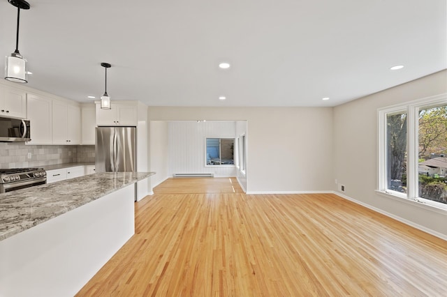 unfurnished living room featuring light wood-type flooring, baseboards, recessed lighting, and a baseboard radiator