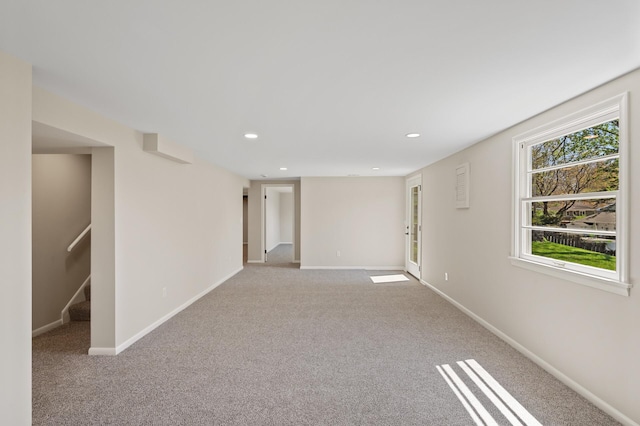 spare room featuring stairs, carpet flooring, baseboards, and recessed lighting