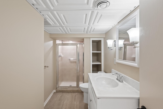 full bath with toilet, a shower stall, vanity, and wood finished floors
