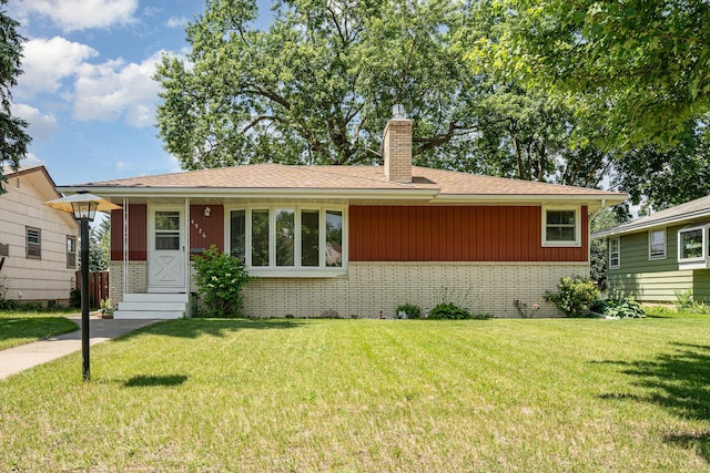4926 Madison St NE, Columbia Heights, MN 55421 - view of front of property with brick siding, a front lawn, a chimney, and a shingled roof