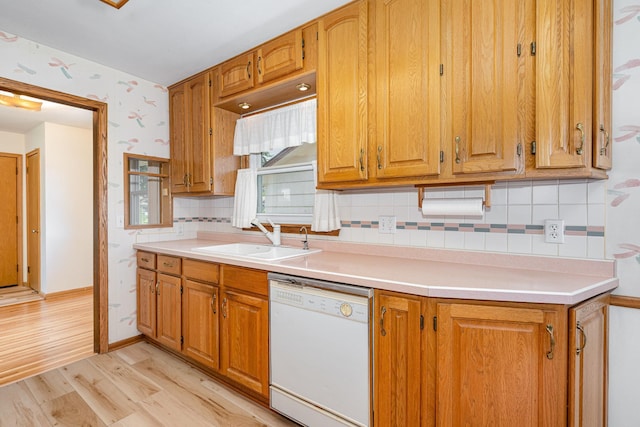 4926 Madison St NE, Columbia Heights, MN 55421 - kitchen featuring white dishwasher, light wood-style floors, decorative backsplash, light countertops, and wallpapered walls