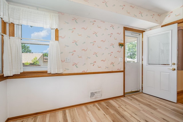 4926 Madison St NE, Columbia Heights, MN 55421 - empty room featuring light wood finished floors and wallpapered walls