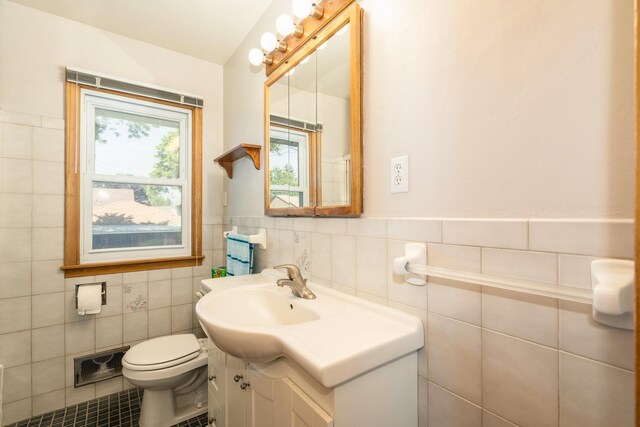 4926 Madison St NE, Columbia Heights, MN 55421 - bathroom with vanity, tile walls, a wainscoted wall, and tile patterned floors