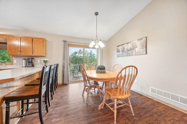 17471 165th St SE, Big Lake, MN 55309 - dining space featuring vaulted ceiling, dark wood-type flooring, a chandelier, and baseboards