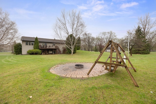 17471 165th St SE, Big Lake, MN 55309 - view of green lawn with a fire pit, a wooden deck, and stairs