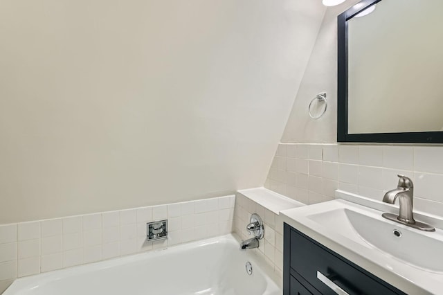 full bath featuring vanity and a bathtub