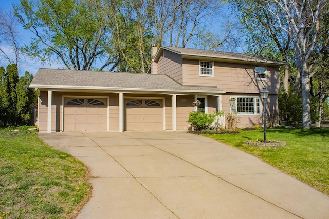 traditional-style home with a garage, concrete driveway, and a front yard