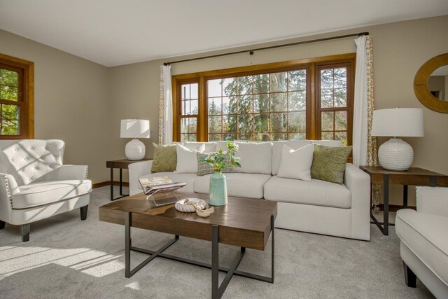 carpeted living area featuring baseboards