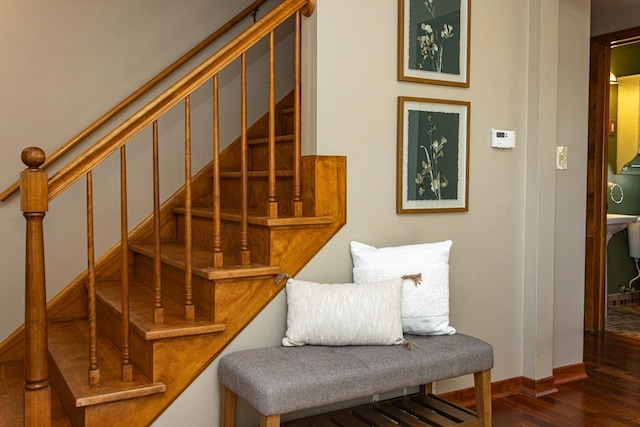 stairs featuring wood finished floors and baseboards