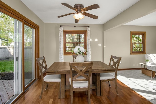 dining area featuring plenty of natural light, wood finished floors, baseboards, and a ceiling fan