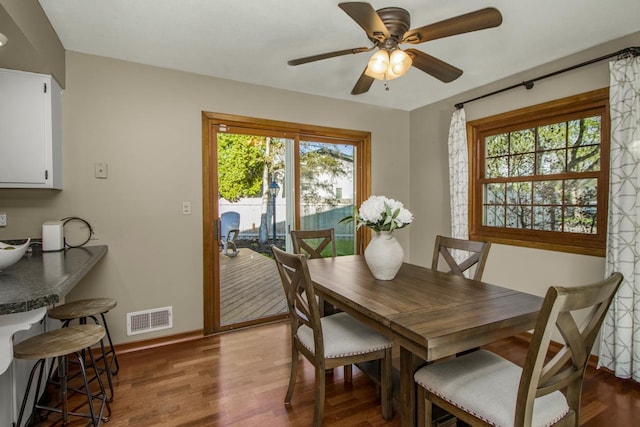 dining space featuring plenty of natural light, wood finished floors, baseboards, and ceiling fan