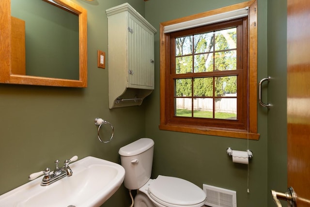 half bathroom with a sink and toilet