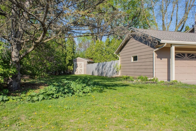 view of yard featuring a shed, a garage, and an outdoor structure