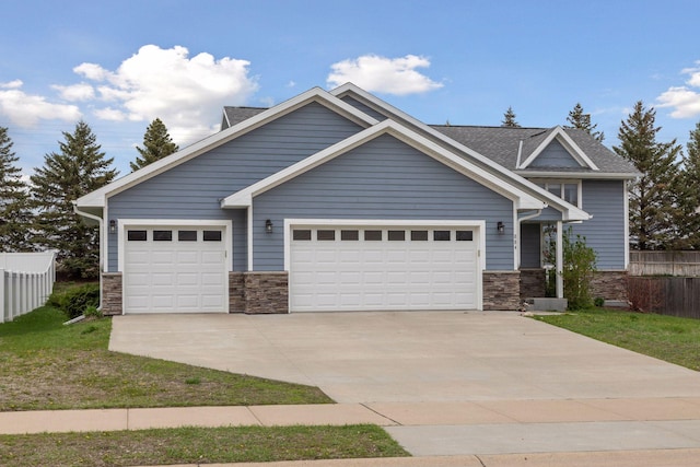 craftsman inspired home featuring driveway, a garage, stone siding, and fence