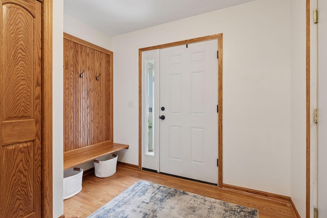 mudroom with wood finished floors and baseboards