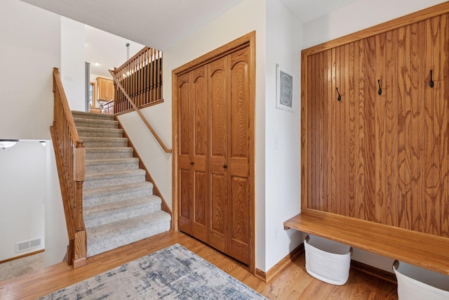 mudroom with wood finished floors and baseboards