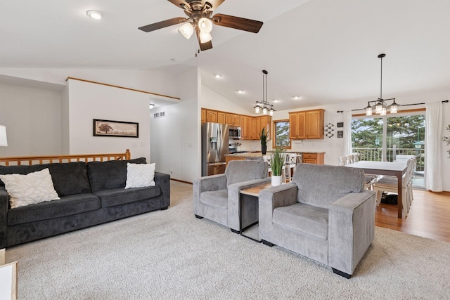 living area featuring light colored carpet, a ceiling fan, recessed lighting, a chandelier, and baseboards