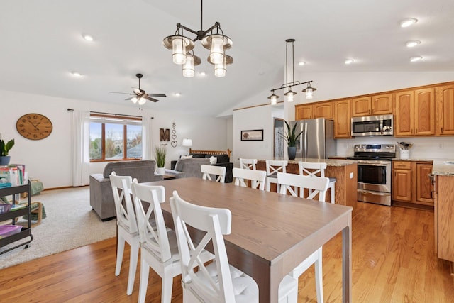 dining room featuring vaulted ceiling, ceiling fan, light wood-type flooring, and recessed lighting